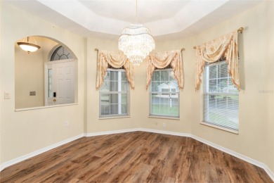 Welcome home to your little sanctuary tucked along the edge of a on Royal Oaks Golf Club in Florida - for sale on GolfHomes.com, golf home, golf lot