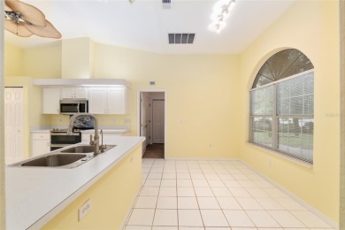 Welcome home to your little sanctuary tucked along the edge of a on Royal Oaks Golf Club in Florida - for sale on GolfHomes.com, golf home, golf lot
