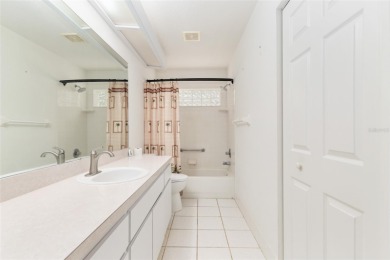Welcome home to your little sanctuary tucked along the edge of a on Royal Oaks Golf Club in Florida - for sale on GolfHomes.com, golf home, golf lot