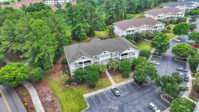 Pond and golf course views from the covered porch on this great on Barefoot Resort and Golf Club  in South Carolina - for sale on GolfHomes.com, golf home, golf lot