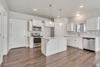 Enjoy laminate floors, an open kitchen with quartz counters on The Ranches Golf Club in Utah - for sale on GolfHomes.com, golf home, golf lot
