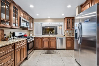 The open-concept family and dining area creates a welcoming on Ocean Hills Country Club in California - for sale on GolfHomes.com, golf home, golf lot