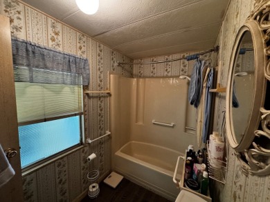Charming 1982 Palm double-wide manufactured home located in the on Rolling Greens Executive Golf Community in Florida - for sale on GolfHomes.com, golf home, golf lot
