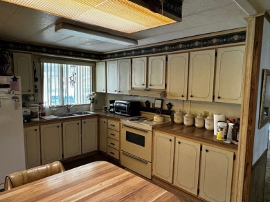 Charming 1982 Palm double-wide manufactured home located in the on Rolling Greens Executive Golf Community in Florida - for sale on GolfHomes.com, golf home, golf lot