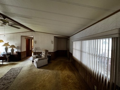 Charming 1982 Palm double-wide manufactured home located in the on Rolling Greens Executive Golf Community in Florida - for sale on GolfHomes.com, golf home, golf lot