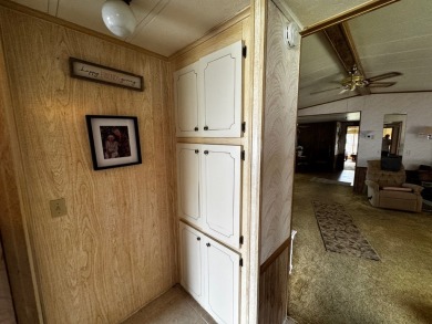 Charming 1982 Palm double-wide manufactured home located in the on Rolling Greens Executive Golf Community in Florida - for sale on GolfHomes.com, golf home, golf lot