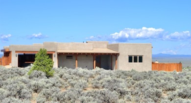 This is a remarkable custom home built in 2025 by renowned local on Taos Country Club in New Mexico - for sale on GolfHomes.com, golf home, golf lot