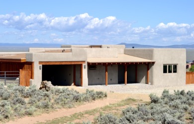 This is a remarkable custom home built in 2025 by renowned local on Taos Country Club in New Mexico - for sale on GolfHomes.com, golf home, golf lot