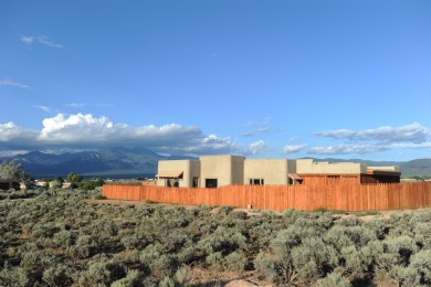 This is a remarkable custom home built in 2025 by renowned local on Taos Country Club in New Mexico - for sale on GolfHomes.com, golf home, golf lot