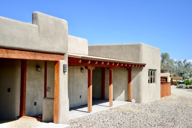 This is a remarkable custom home built in 2025 by renowned local on Taos Country Club in New Mexico - for sale on GolfHomes.com, golf home, golf lot