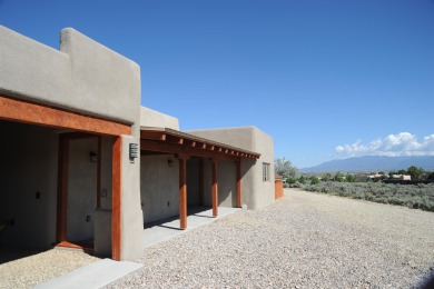 This is a remarkable custom home built in 2025 by renowned local on Taos Country Club in New Mexico - for sale on GolfHomes.com, golf home, golf lot