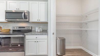This home features 2 bedrooms and a flex room with french doors on Brunswick Plantation and Golf Resorts in North Carolina - for sale on GolfHomes.com, golf home, golf lot