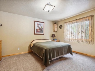 Nestled on a tranquil dead-end road, this stunning four-bedroom on Deacons Lodge Golf Course in Minnesota - for sale on GolfHomes.com, golf home, golf lot