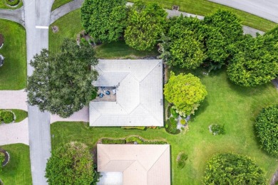 Welcome to your tranquil retreat featuring a captivating garden on Quail Ridge Golf Course and Country Club in Florida - for sale on GolfHomes.com, golf home, golf lot