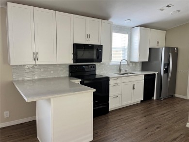 Enjoy the perfect blend of style & comfort in this partially on Mangrove Bay Golf Course in Florida - for sale on GolfHomes.com, golf home, golf lot