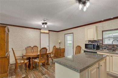This practically NEW 2021 Built 3/2 Split plan home is located on Zellwood Station Country Club in Florida - for sale on GolfHomes.com, golf home, golf lot