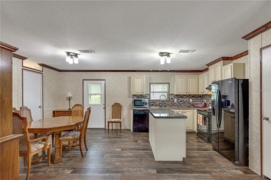 This practically NEW 2021 Built 3/2 Split plan home is located on Zellwood Station Country Club in Florida - for sale on GolfHomes.com, golf home, golf lot