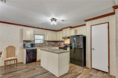 This practically NEW 2021 Built 3/2 Split plan home is located on Zellwood Station Country Club in Florida - for sale on GolfHomes.com, golf home, golf lot