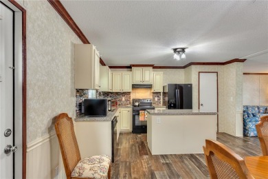 This practically NEW 2021 Built 3/2 Split plan home is located on Zellwood Station Country Club in Florida - for sale on GolfHomes.com, golf home, golf lot