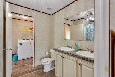 This practically NEW 2021 Built 3/2 Split plan home is located on Zellwood Station Country Club in Florida - for sale on GolfHomes.com, golf home, golf lot