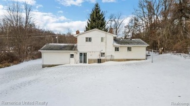 This charming tri-level home is situated on 2.5 acres of on Pine Knob Golf Club - Hawk in Michigan - for sale on GolfHomes.com, golf home, golf lot