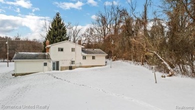 This charming tri-level home is situated on 2.5 acres of on Pine Knob Golf Club - Hawk in Michigan - for sale on GolfHomes.com, golf home, golf lot