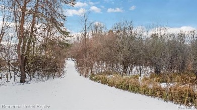 This charming tri-level home is situated on 2.5 acres of on Pine Knob Golf Club - Hawk in Michigan - for sale on GolfHomes.com, golf home, golf lot