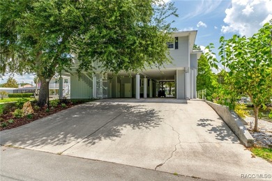 This updated waterfront stilt (DID NOT FLOOD) home in Crystal on Plantation Inn and Golf Resort  in Florida - for sale on GolfHomes.com, golf home, golf lot