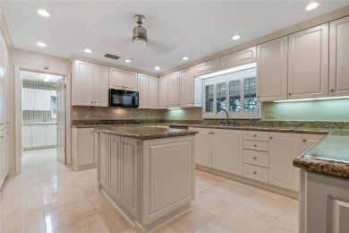 Step into timeless elegance in this stunning Colonial-style on Feather Sound Country Club in Florida - for sale on GolfHomes.com, golf home, golf lot