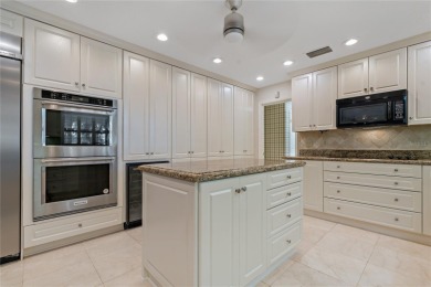 Step into timeless elegance in this stunning Colonial-style on Feather Sound Country Club in Florida - for sale on GolfHomes.com, golf home, golf lot