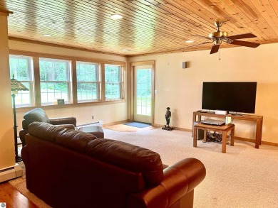 Discover unparalleled executive living perfectly situated on the on Traverse City Golf and Country Club in Michigan - for sale on GolfHomes.com, golf home, golf lot