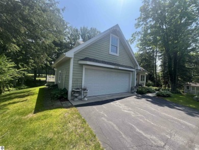Discover unparalleled executive living perfectly situated on the on Traverse City Golf and Country Club in Michigan - for sale on GolfHomes.com, golf home, golf lot