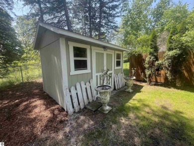 Discover unparalleled executive living perfectly situated on the on Traverse City Golf and Country Club in Michigan - for sale on GolfHomes.com, golf home, golf lot