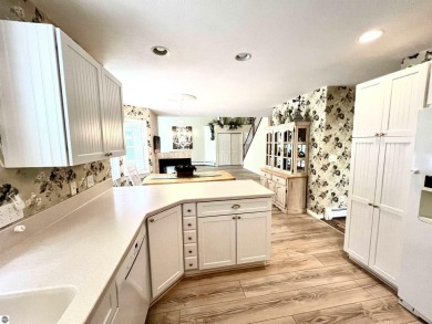 Discover unparalleled executive living perfectly situated on the on Traverse City Golf and Country Club in Michigan - for sale on GolfHomes.com, golf home, golf lot