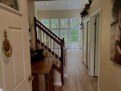 Discover unparalleled executive living perfectly situated on the on Traverse City Golf and Country Club in Michigan - for sale on GolfHomes.com, golf home, golf lot