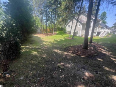 Discover unparalleled executive living perfectly situated on the on Traverse City Golf and Country Club in Michigan - for sale on GolfHomes.com, golf home, golf lot