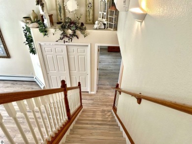 Discover unparalleled executive living perfectly situated on the on Traverse City Golf and Country Club in Michigan - for sale on GolfHomes.com, golf home, golf lot