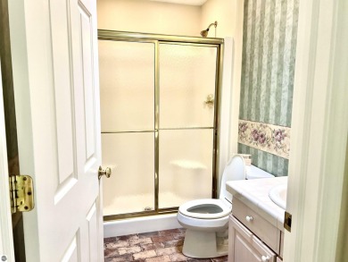 Discover unparalleled executive living perfectly situated on the on Traverse City Golf and Country Club in Michigan - for sale on GolfHomes.com, golf home, golf lot
