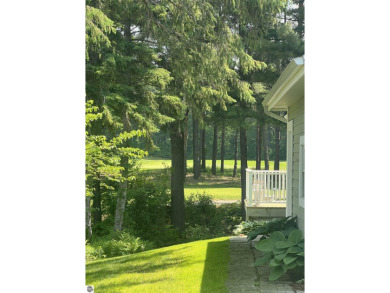Discover unparalleled executive living perfectly situated on the on Traverse City Golf and Country Club in Michigan - for sale on GolfHomes.com, golf home, golf lot