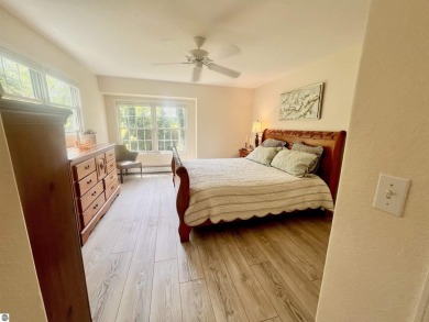 Discover unparalleled executive living perfectly situated on the on Traverse City Golf and Country Club in Michigan - for sale on GolfHomes.com, golf home, golf lot