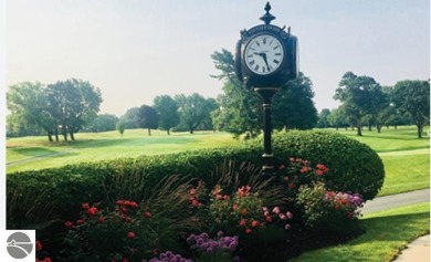 Discover unparalleled executive living perfectly situated on the on Traverse City Golf and Country Club in Michigan - for sale on GolfHomes.com, golf home, golf lot