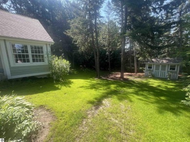 Discover unparalleled executive living perfectly situated on the on Traverse City Golf and Country Club in Michigan - for sale on GolfHomes.com, golf home, golf lot