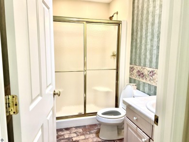 Discover unparalleled executive living perfectly situated on the on Traverse City Golf and Country Club in Michigan - for sale on GolfHomes.com, golf home, golf lot