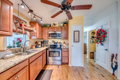 This great two-bed, two-bath home is located on the course at on Pine Lakes Country Club in Florida - for sale on GolfHomes.com, golf home, golf lot