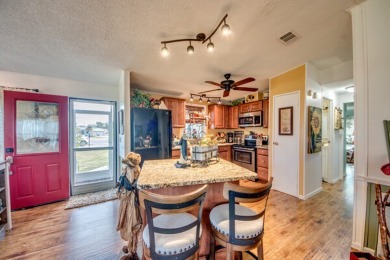 This great two-bed, two-bath home is located on the course at on Pine Lakes Country Club in Florida - for sale on GolfHomes.com, golf home, golf lot