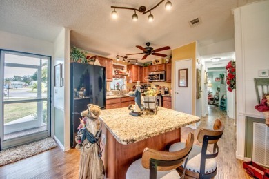 This great two-bed, two-bath home is located on the course at on Pine Lakes Country Club in Florida - for sale on GolfHomes.com, golf home, golf lot