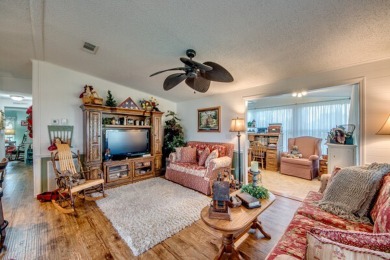 This great two-bed, two-bath home is located on the course at on Pine Lakes Country Club in Florida - for sale on GolfHomes.com, golf home, golf lot