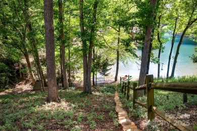 Why just live near the lake when you can live on it? This on Tega Cay Golf Club in South Carolina - for sale on GolfHomes.com, golf home, golf lot