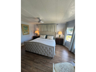 This charming two-bedroom, two-bath home is located in the gated on Lake Fairways Country Club in Florida - for sale on GolfHomes.com, golf home, golf lot