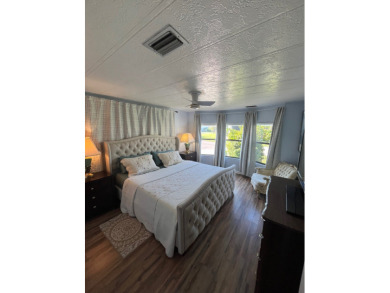 This charming two-bedroom, two-bath home is located in the gated on Lake Fairways Country Club in Florida - for sale on GolfHomes.com, golf home, golf lot